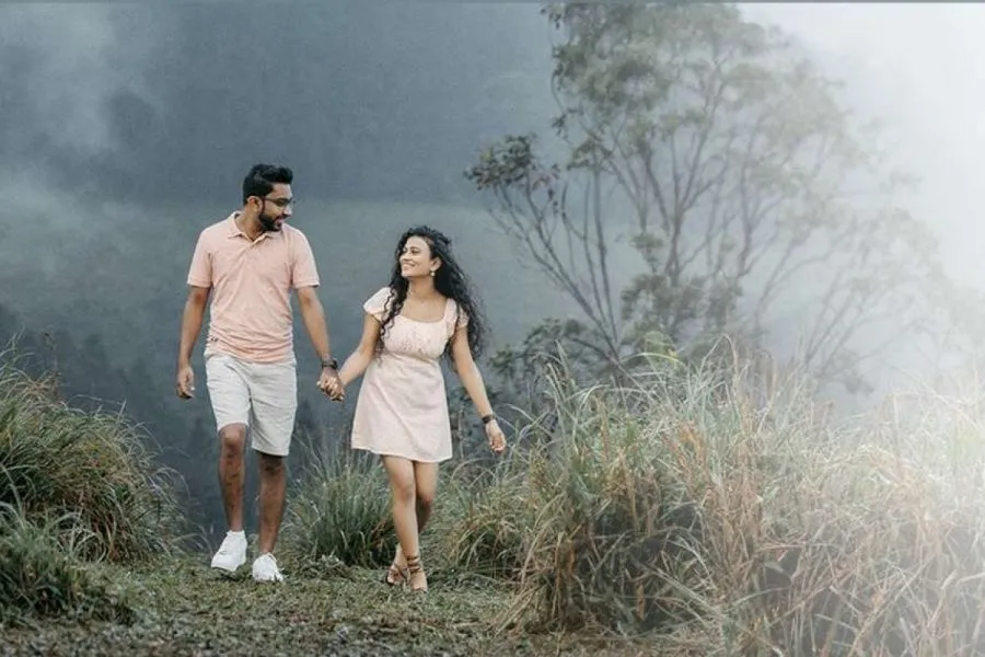 Couple walking through misty grass in a pre-wedding film