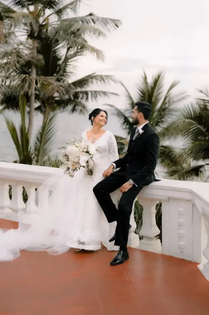 Bride and groom sitting together on a balcony