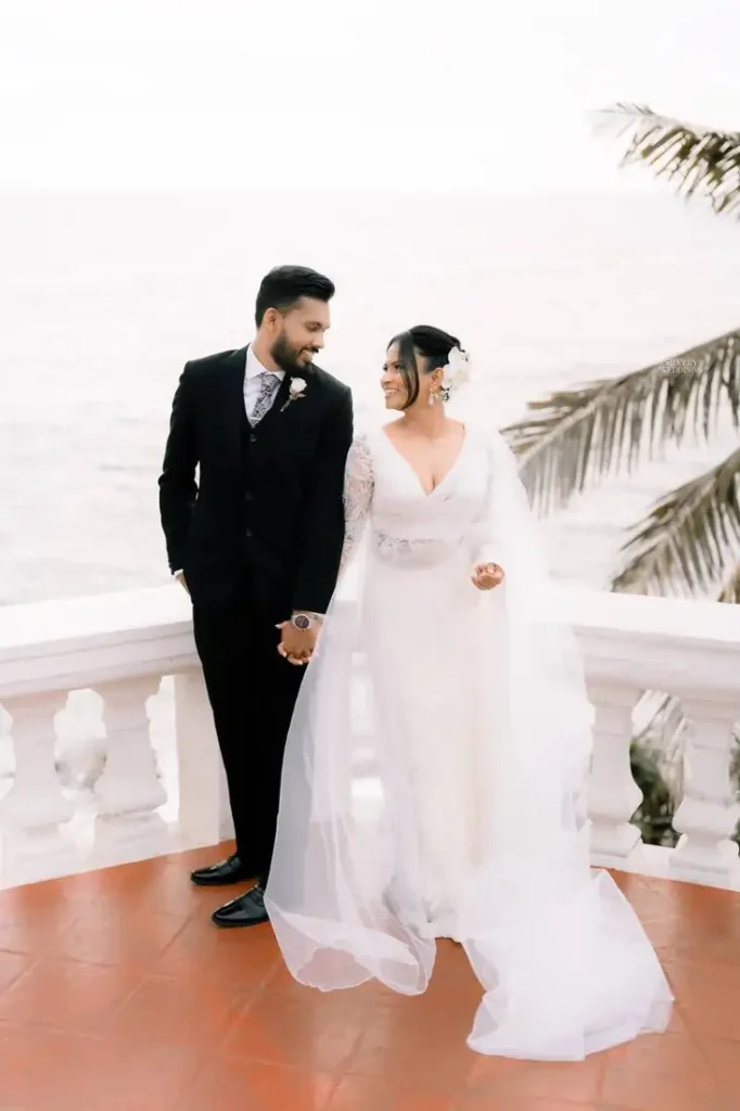 Bride and groom standing on a balcony